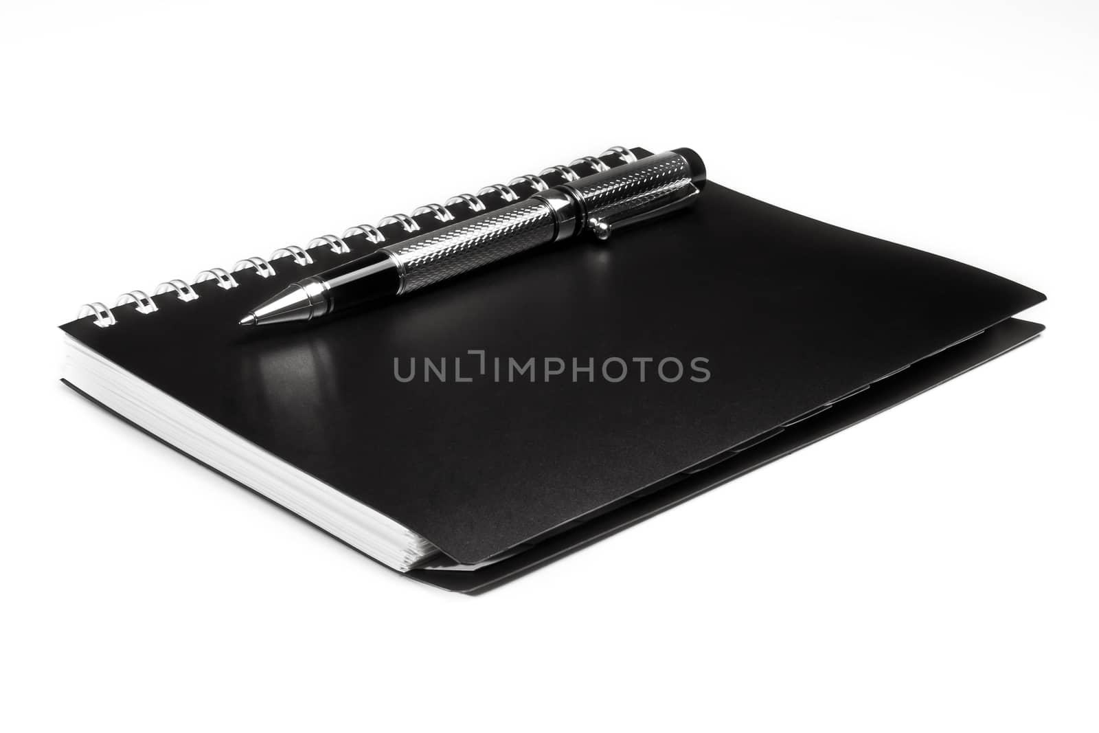 black notebook and pen over a white background
