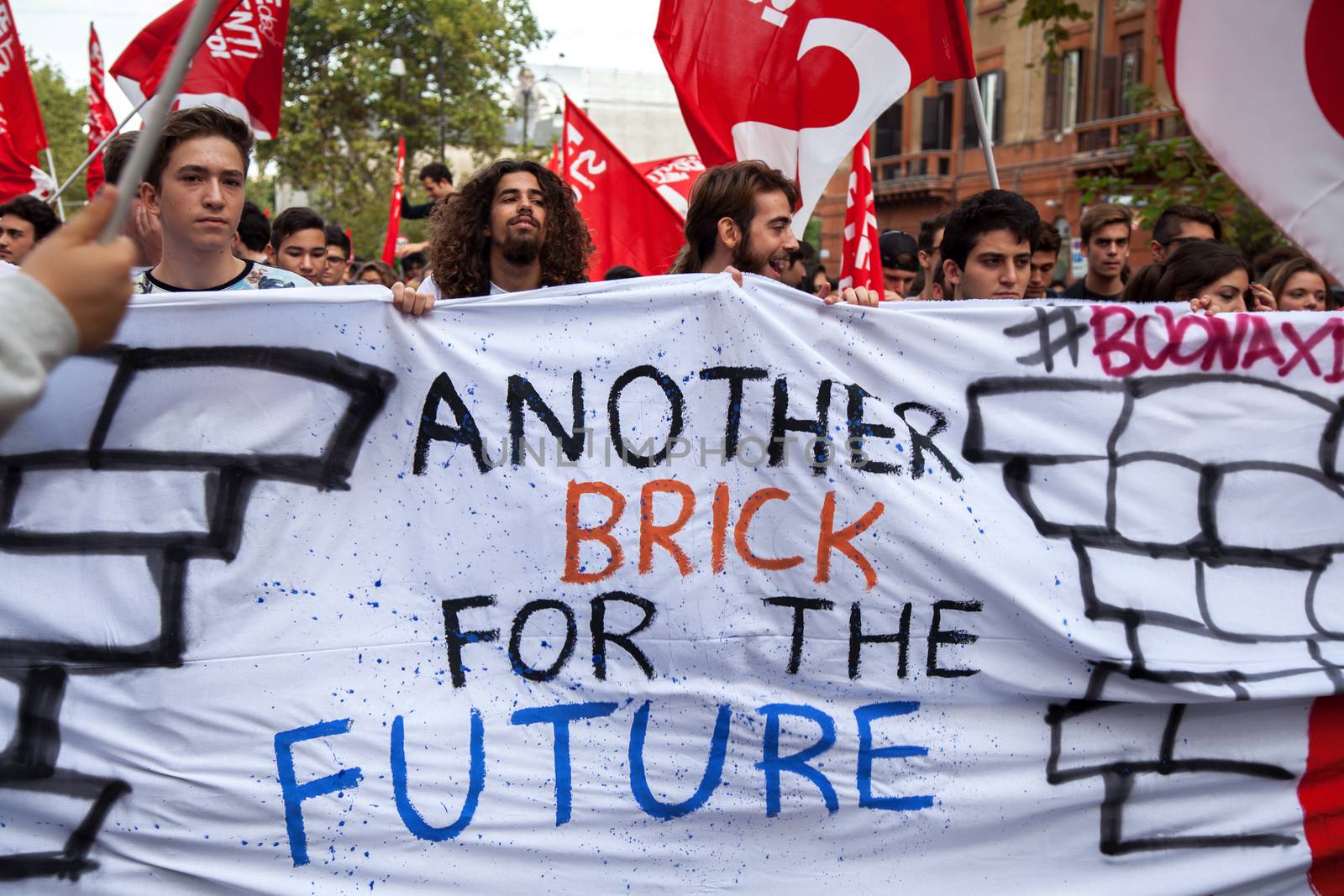 ITALY, Palermo: Thousands of students marched and held banners against Renzi's school reform in Palermo, Italy on October 9, 2015.A theme of the protests is the revisions to the calculation of family income, which some say will reduce scholarships and housing for students. Students throughout the country protested what's know as La Buona Scuola.  A spokesman for the protesters said they were going to announce a week of mobilization lasting until October 17. They plan to launch an attack for free education and reversal of policies. 