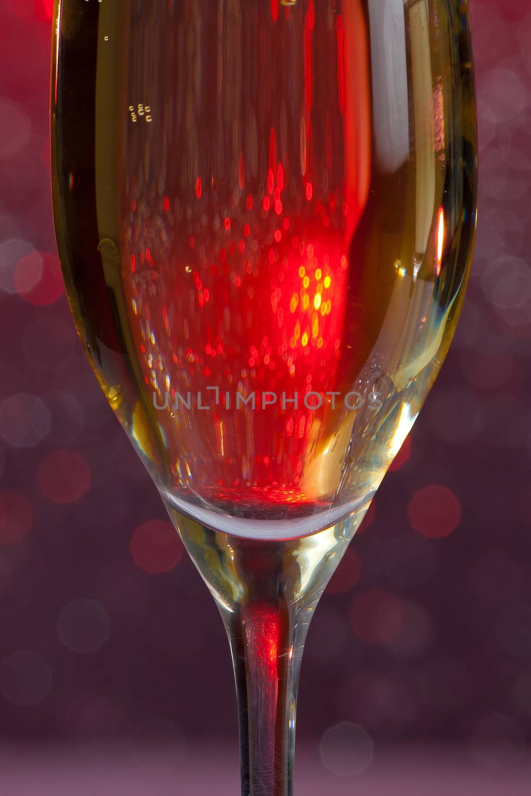 one half flute of champagne on abstract background by donfiore