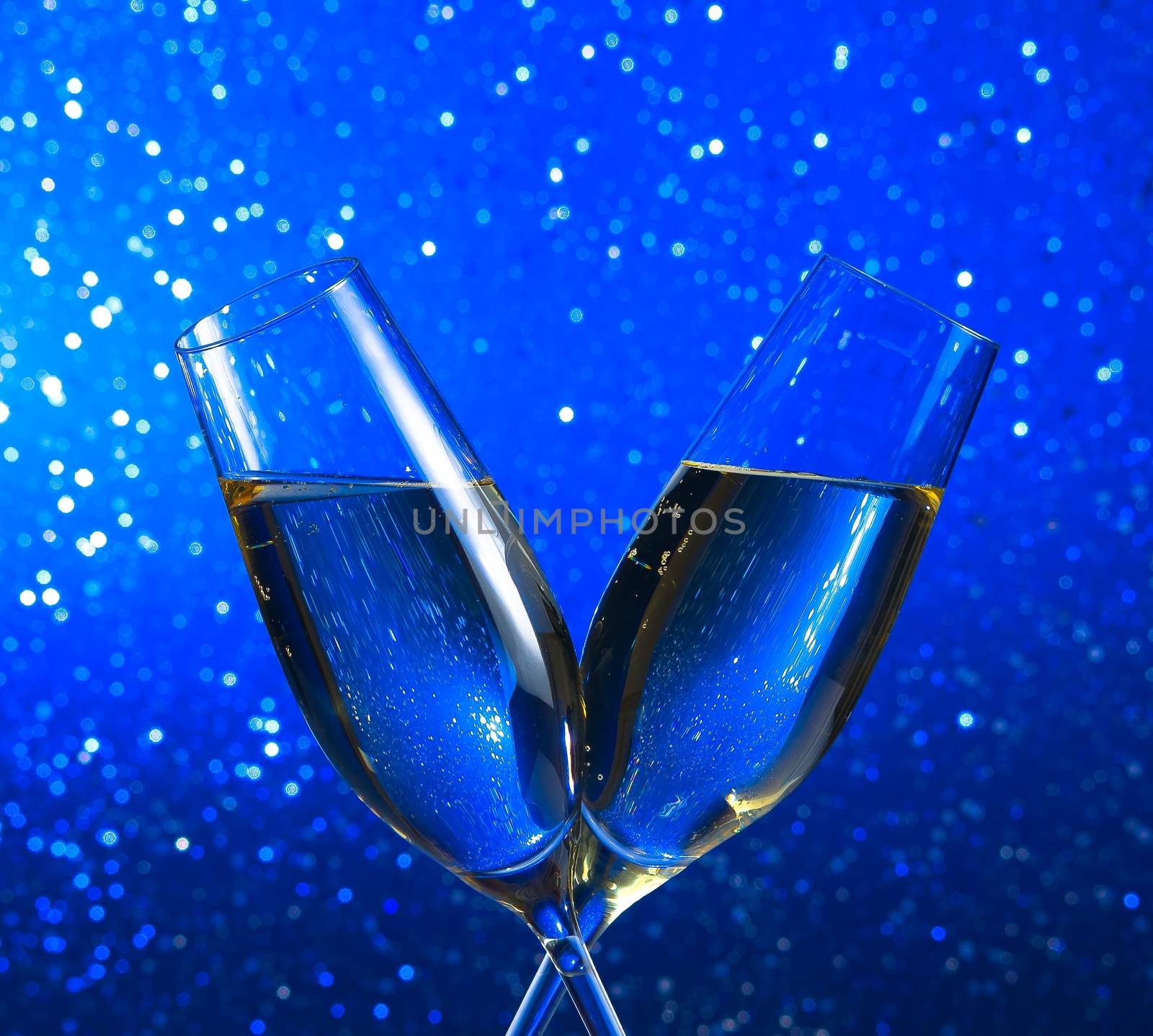champagne flutes on blue light bokeh background by donfiore