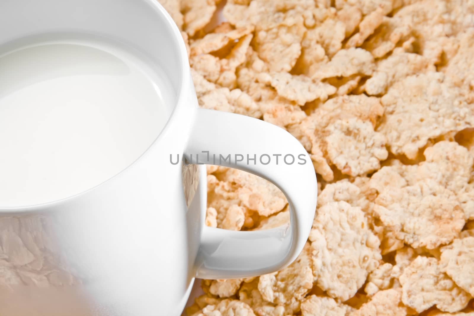 detail of milk on corn flakes background, breakfast concept