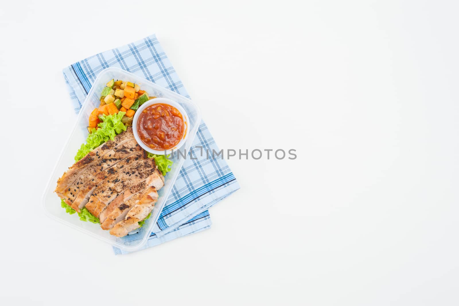 Roasted pork with three flavoured (sweet, sour, spicy) sauce cooked by clean food concept with vegetables in lunch box