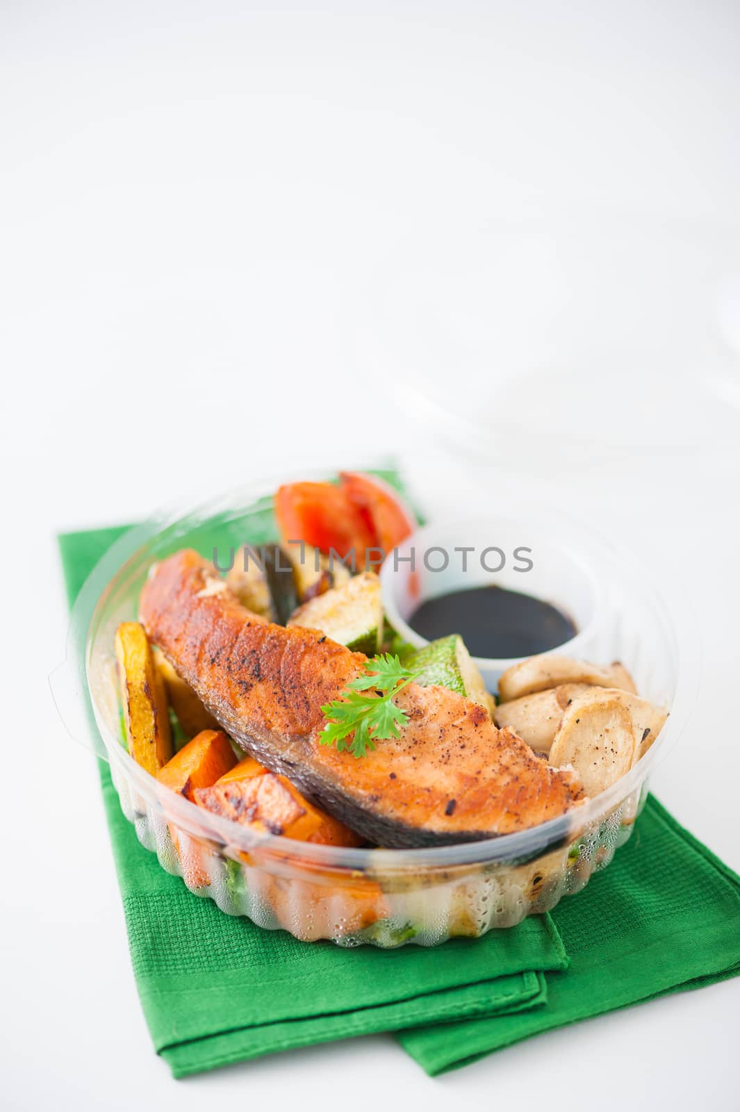 Salmon steak and grilled vegetables cooked by clean food concept with Japanese sesame soy sauce in lunch box