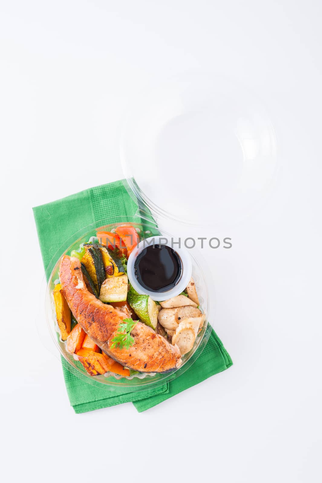 Salmon steak and grilled vegetables cooked by clean food concept with Japanese sesame soy sauce in lunch box