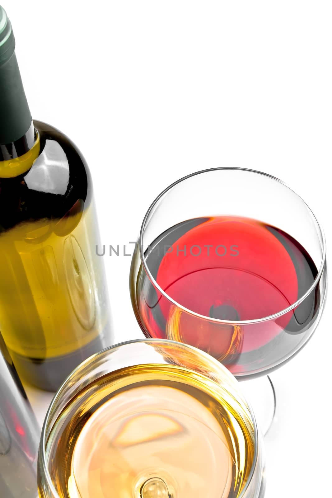 top of view of red and white wine glasses near wine bottle on white background