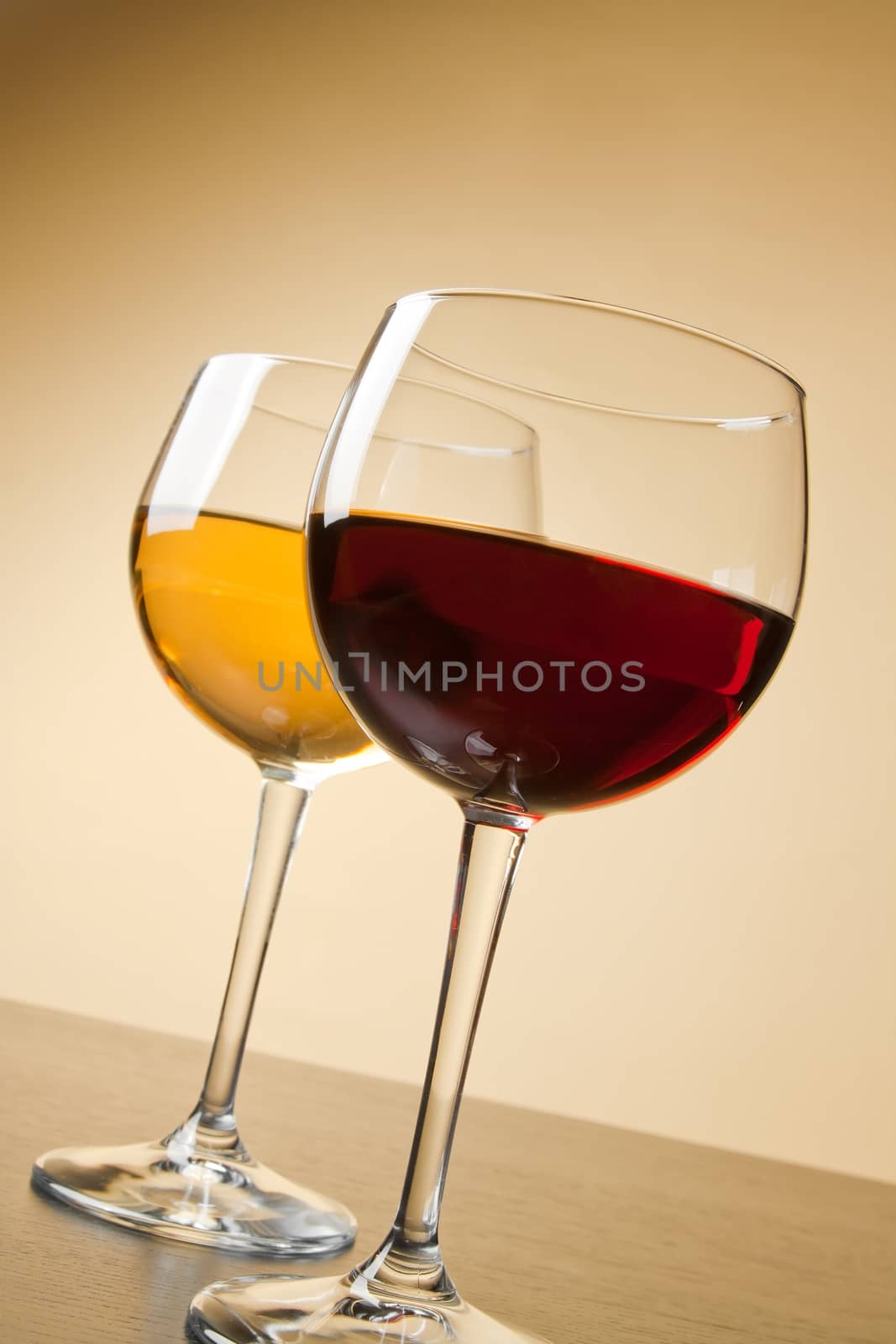 red and white wine glasses on table by donfiore