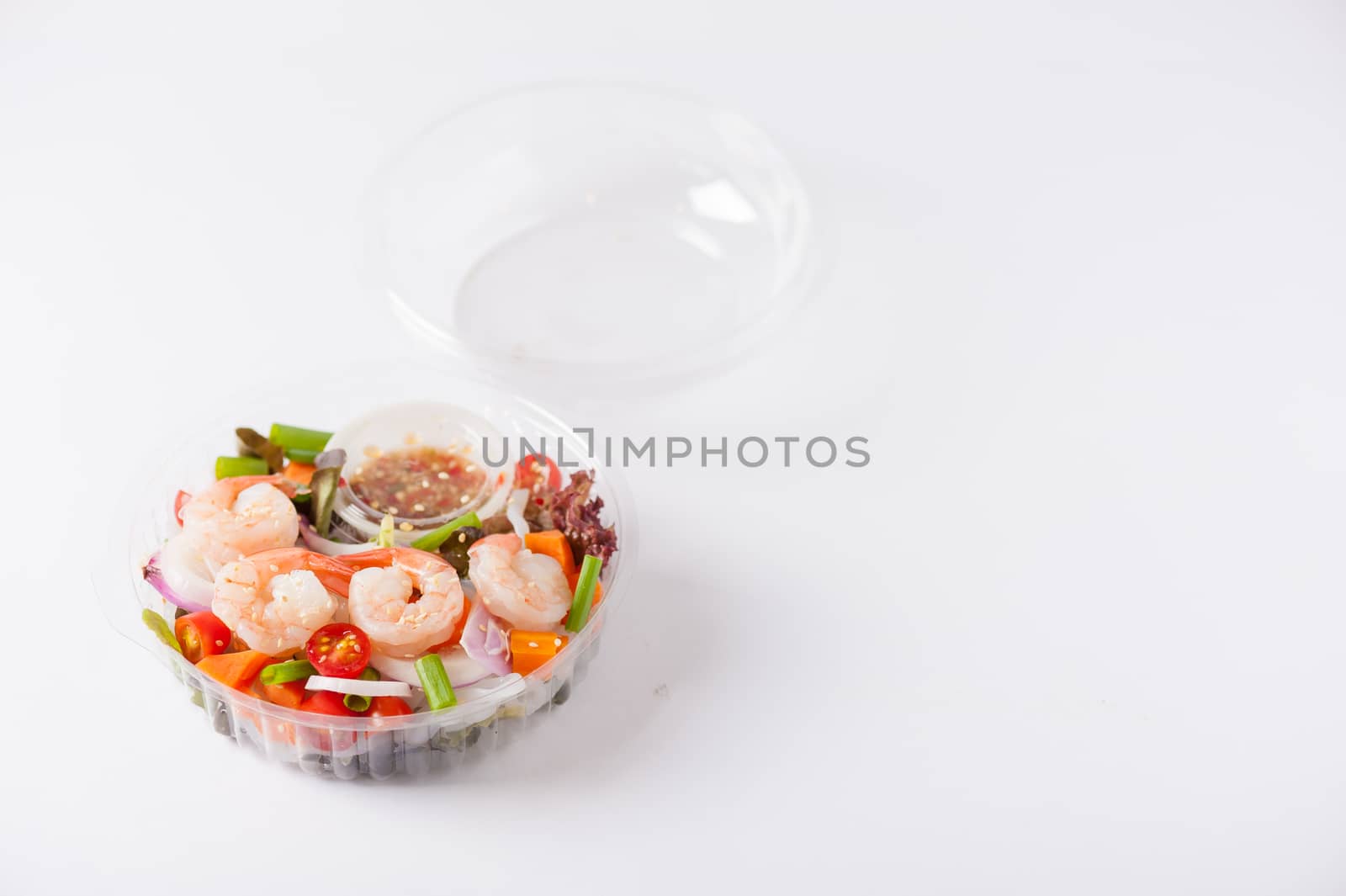 Thai spicy salad with shrimps cooked by clean food concept in lunch box on white table
