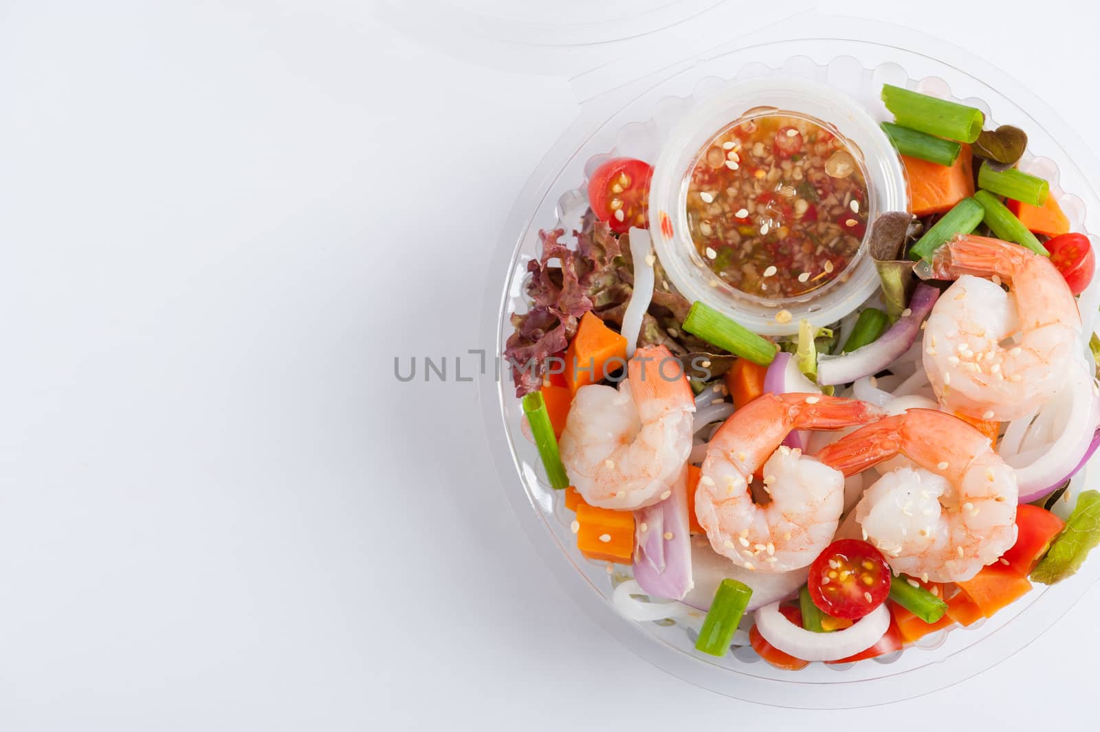 Thai spicy salad with shrimps cooked by clean food concept in lunch box on white table
