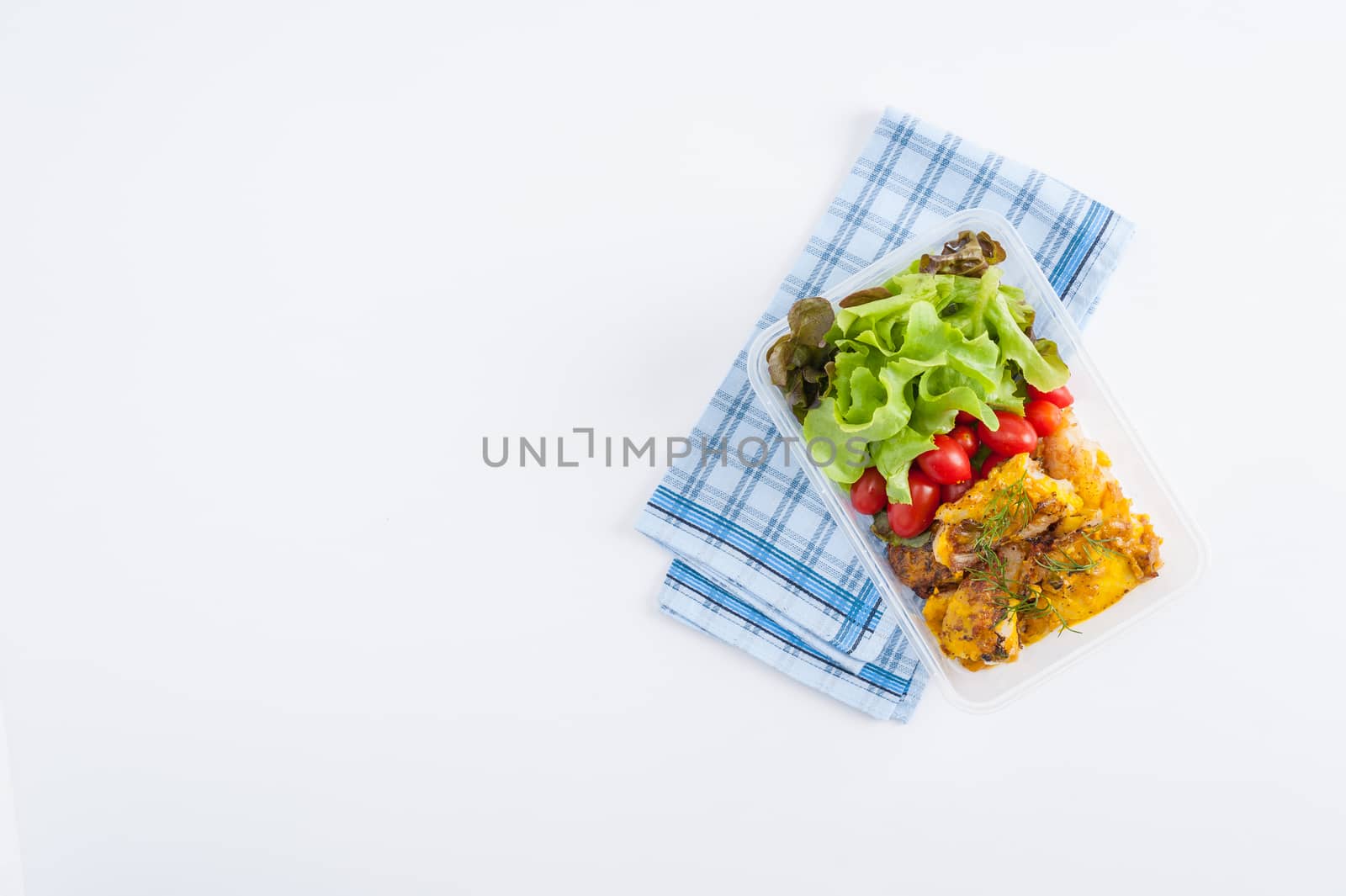 Pangasius fish with mayo mustard sauce cooked by clean food concept and salad in lunch box on white table