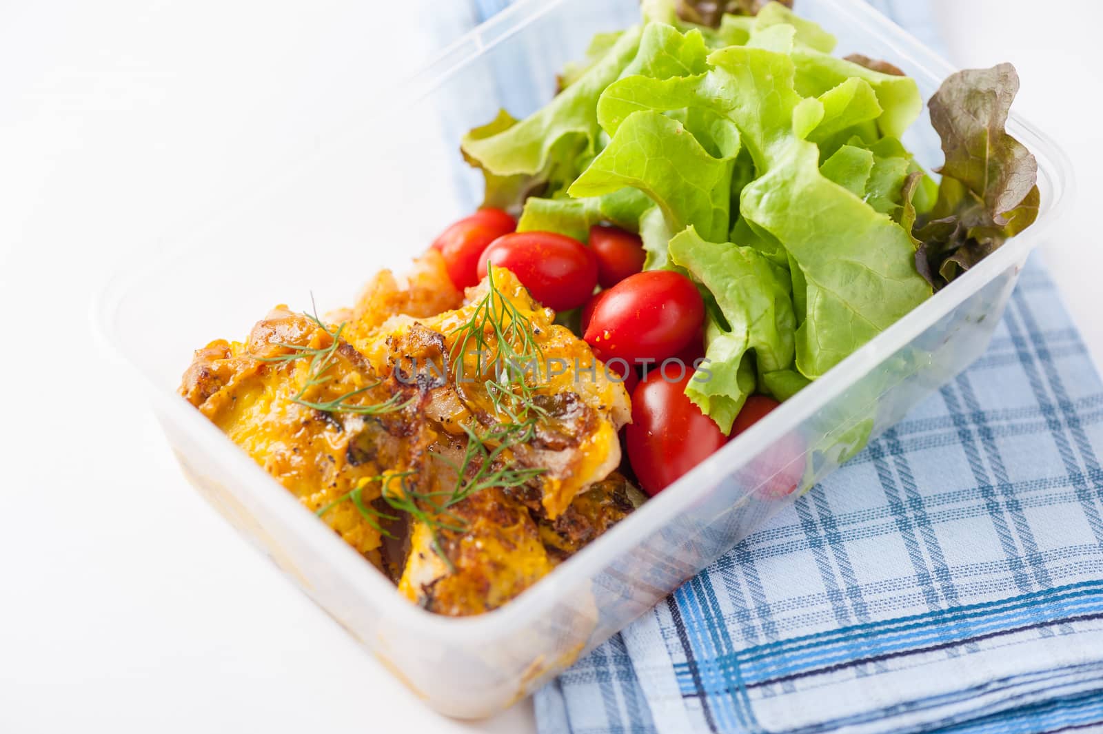 Pangasius fish with mayo mustard sauce cooked by clean food concept and salad in lunch box on white table