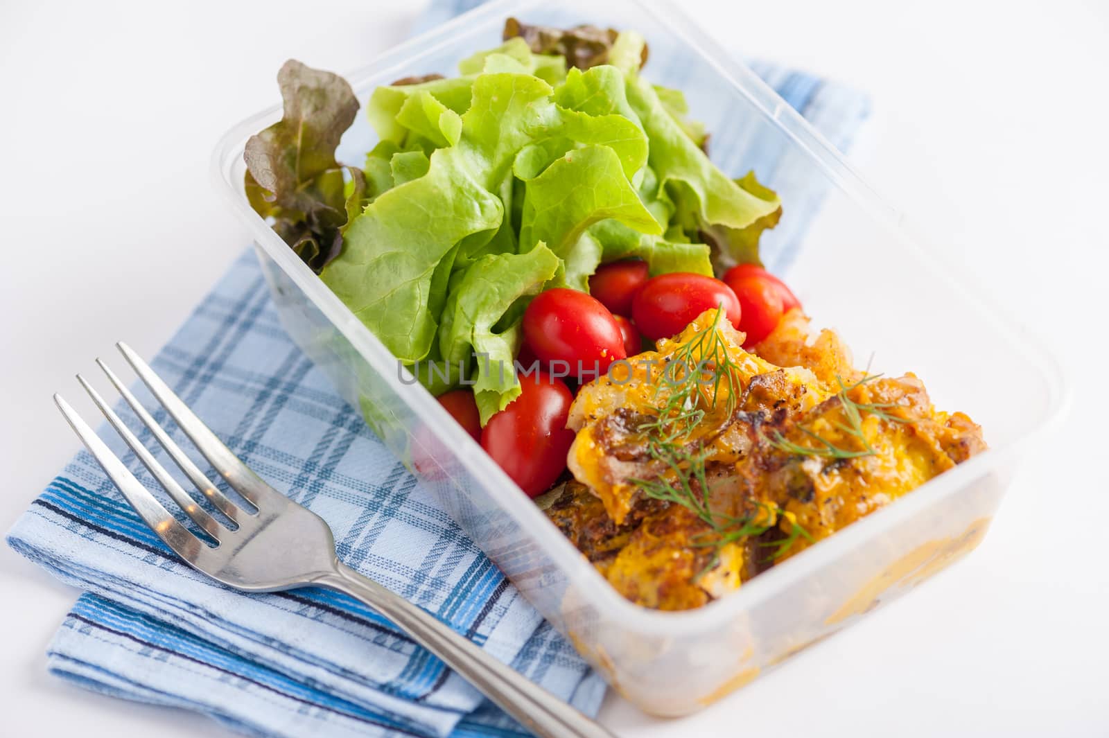 Pangasius fish with mayo mustard sauce cooked by clean food concept and salad in lunch box on white table