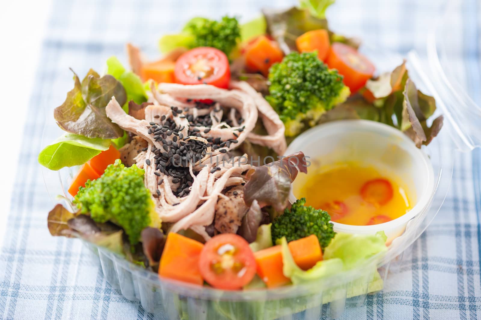 Chicken breast salad with honey thyme sauce cooked by clean food concept in lunch box on white table