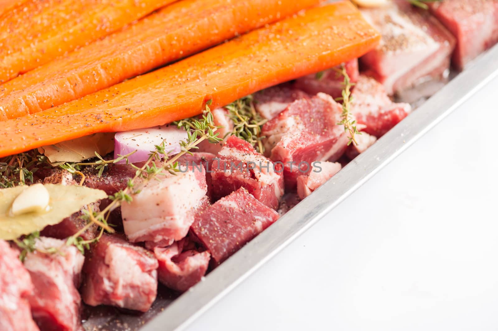 Ingredients for making pork stock soup in steel tray on white table