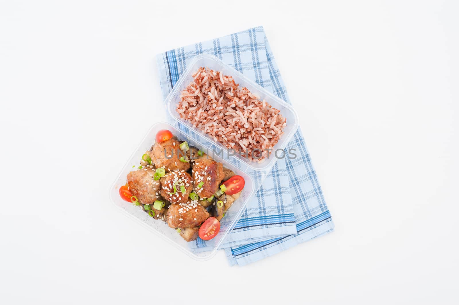 Tsukune (Japanese chicken meatballs) cooked by clean food concept with brown rice in lunch box on white table