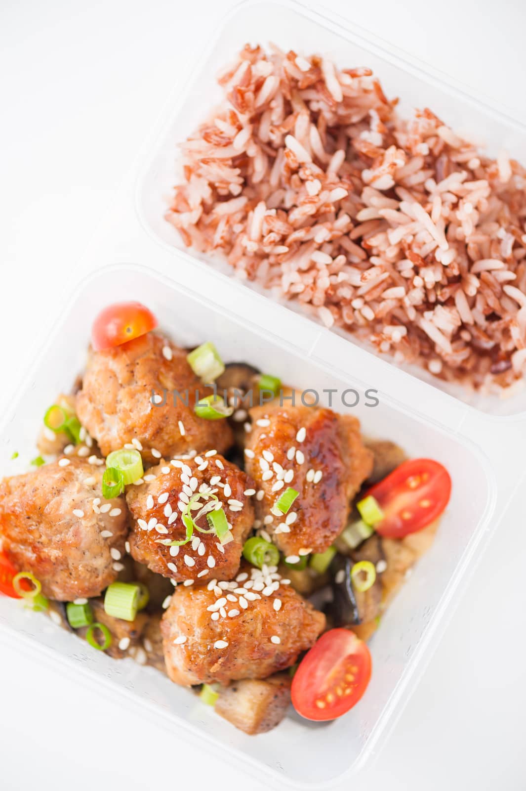 Tsukune (Japanese chicken meatballs) cooked by clean food concept with brown rice in lunch box