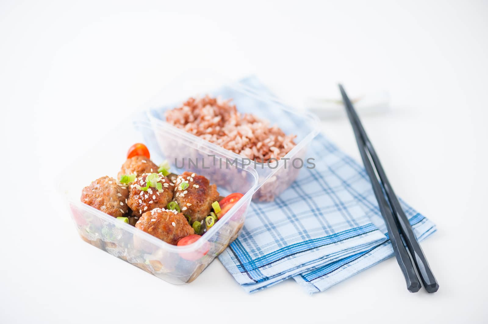 Tsukune (Japanese chicken meatballs) cooked by clean food concept with brown rice in lunch box