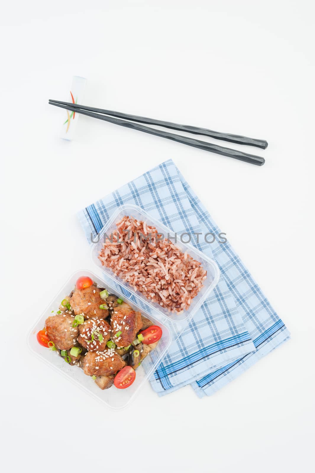 Tsukune (Japanese chicken meatballs) cooked by clean food concept with brown rice in lunch box