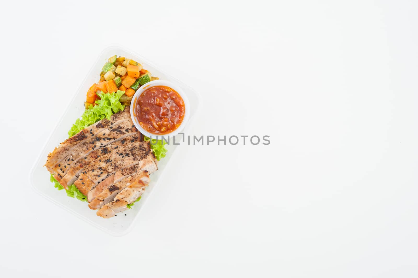 Roasted pork with three flavoured (sweet, sour, spicy) sauce cooked by clean food concept with vegetables in lunch box