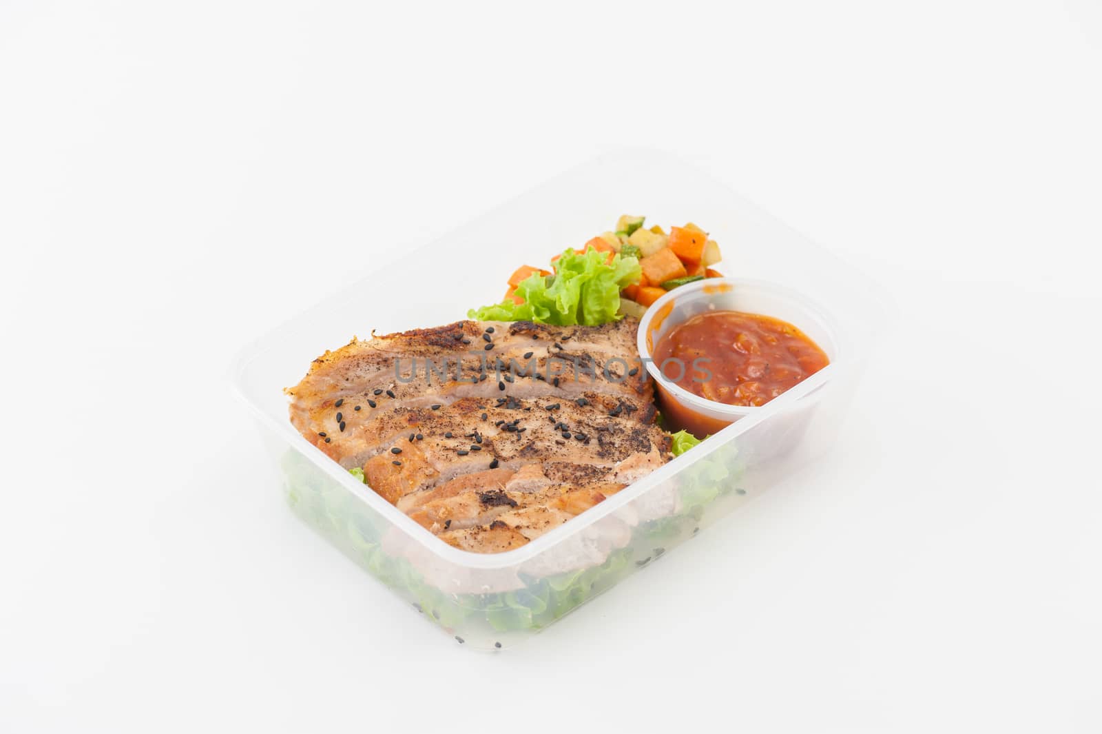 Roasted pork with three flavoured (sweet, sour, spicy) sauce cooked by clean food concept with vegetables in lunch box