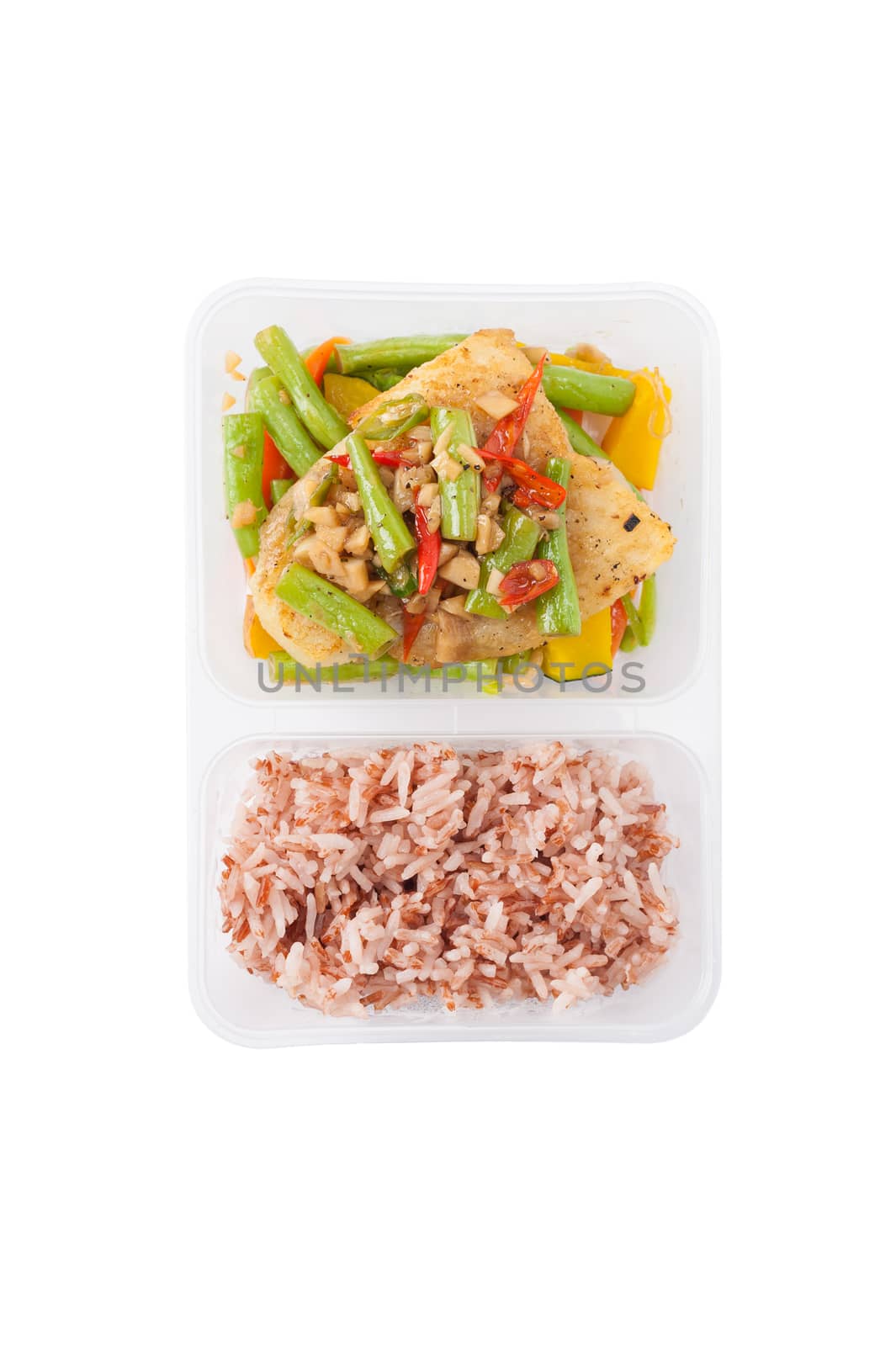 Pangasius fish fried with chili and vegetables cooked by clean food concept with brown rice in lunch box on white table
