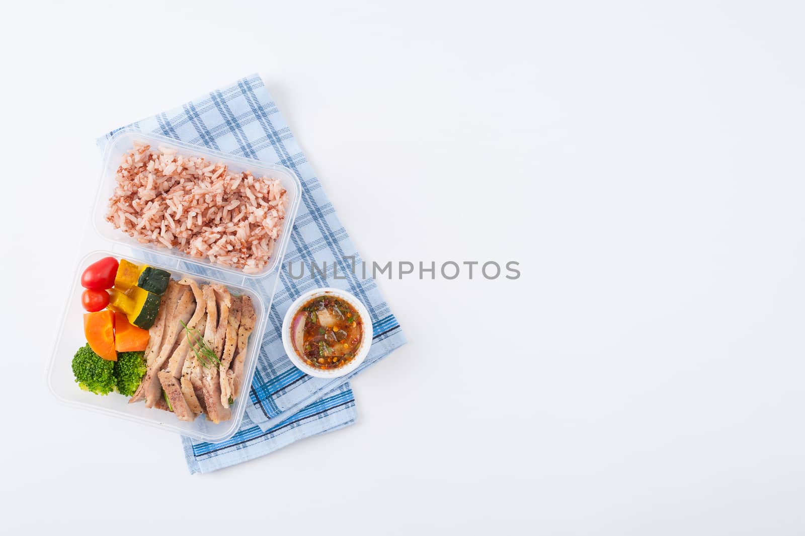 Roasted pork tenderloin with vegetables cooked by clean food concept with brown rice and Northern Thai local sauce on white table