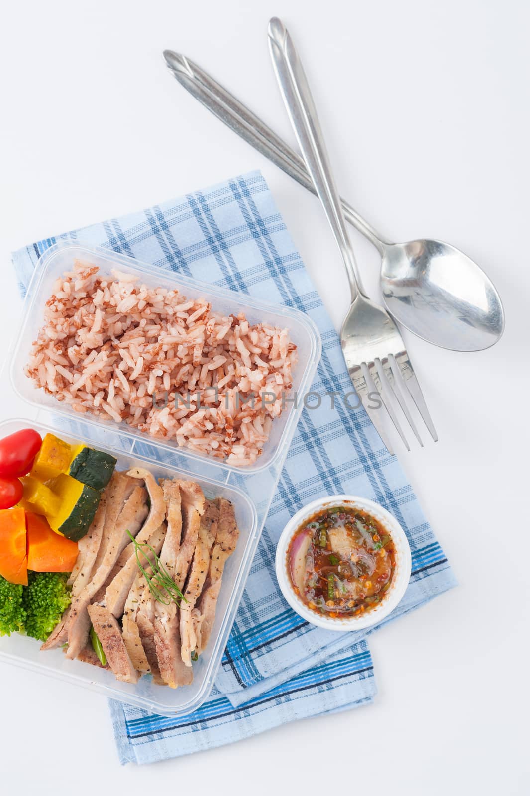 Roasted pork tenderloin with vegetables cooked by clean food concept with brown rice and Northern Thai local sauce on white table