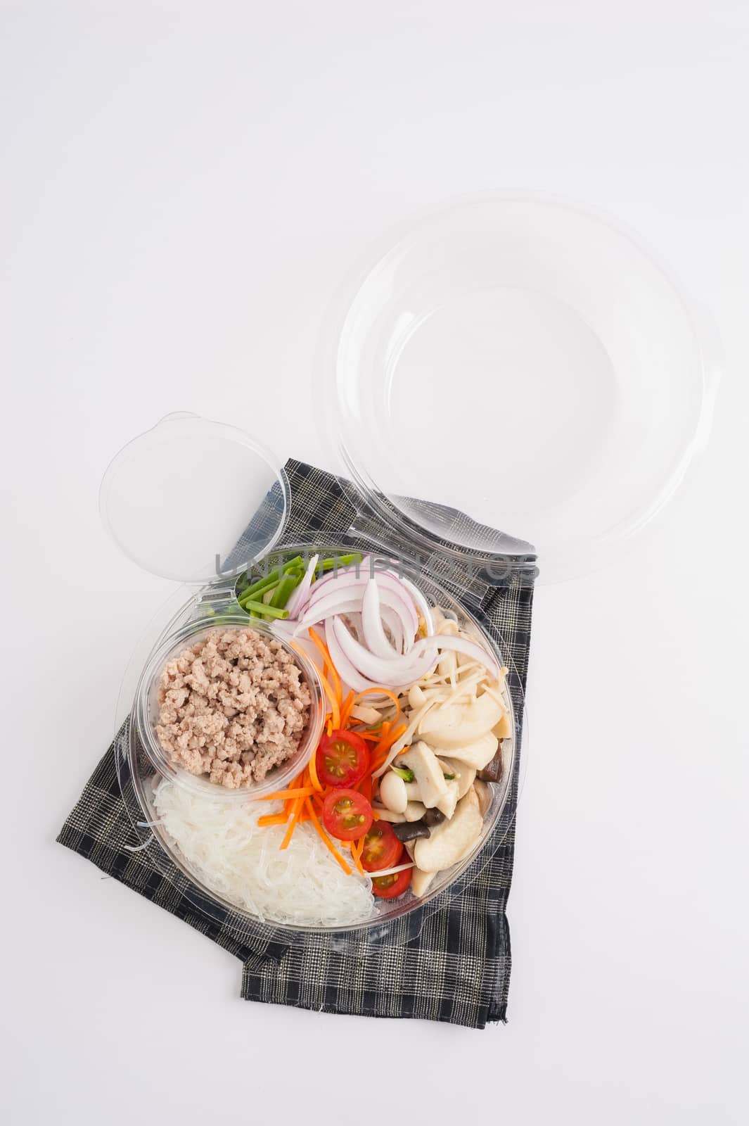 Thai spicy salad with minced pork, mushroom, vegetables and vermicelli cooked by clean food concept on white table