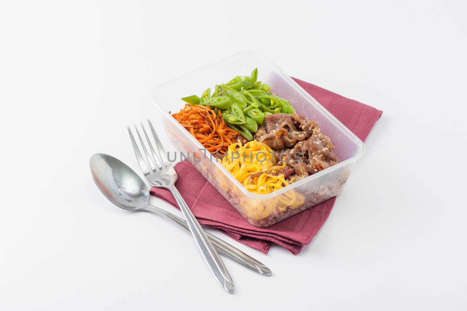 Bibimbub in clean food style. Brown rice with roasted pork, egg, and vegetables on white table