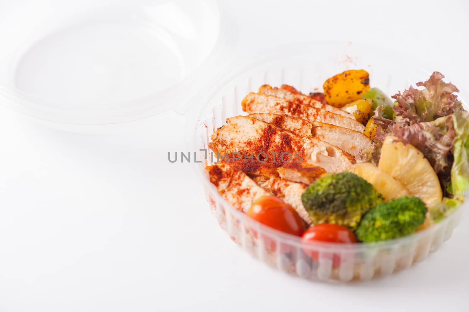 Roasted chicken with paprika powder cooked by clean food concept and salad in lunch box on white table