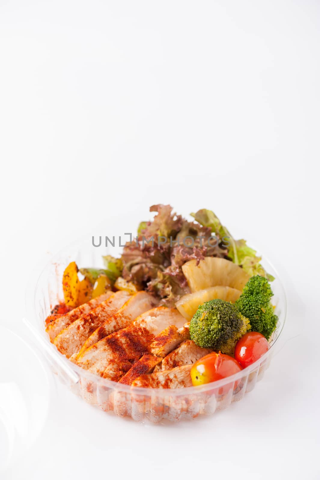 Roasted chicken with paprika powder cooked by clean food concept and salad in lunch box on white table
