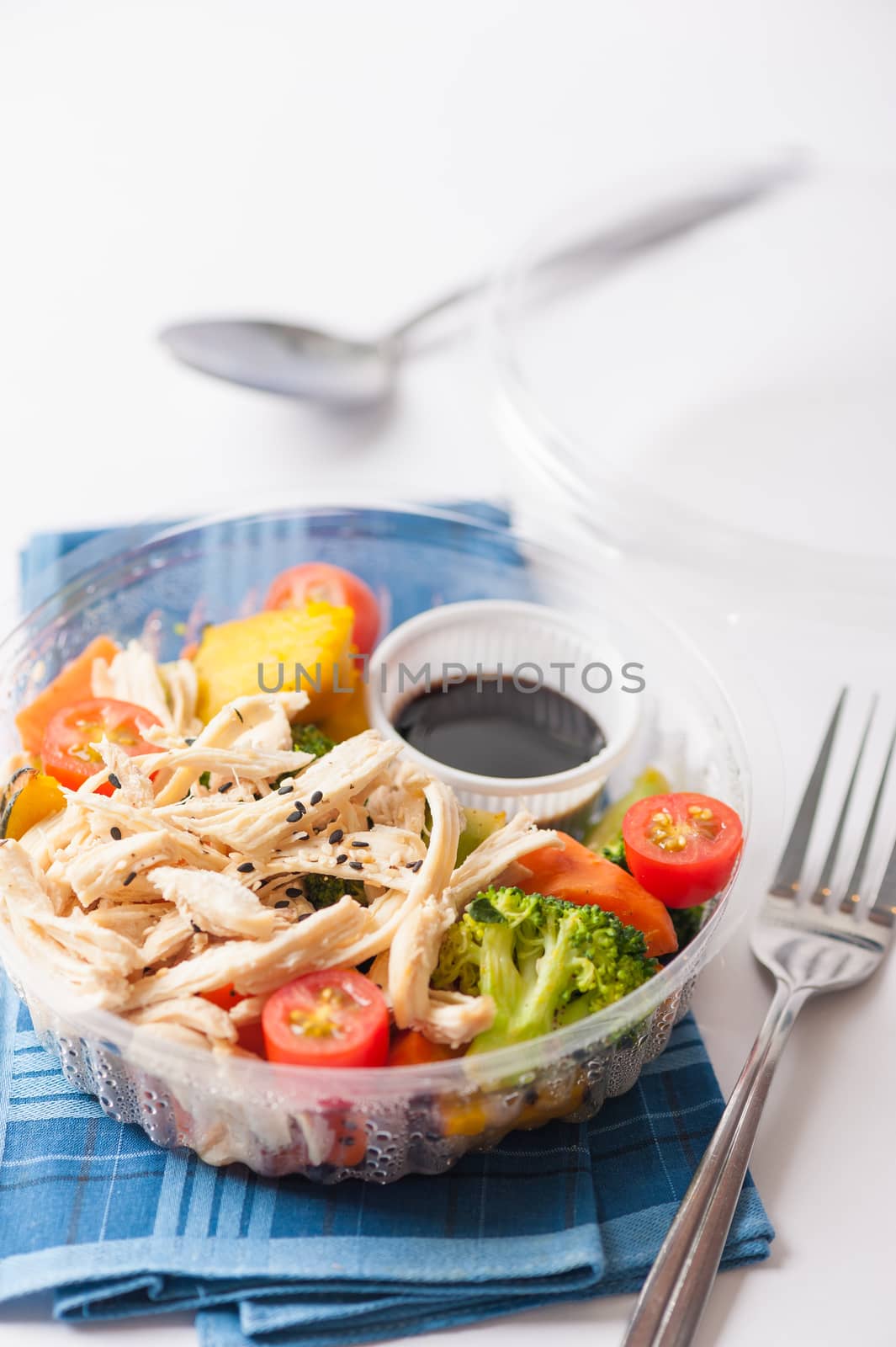 Salad soba with vegetables and shred chicken cooked by clean food concept in lunch box on white table