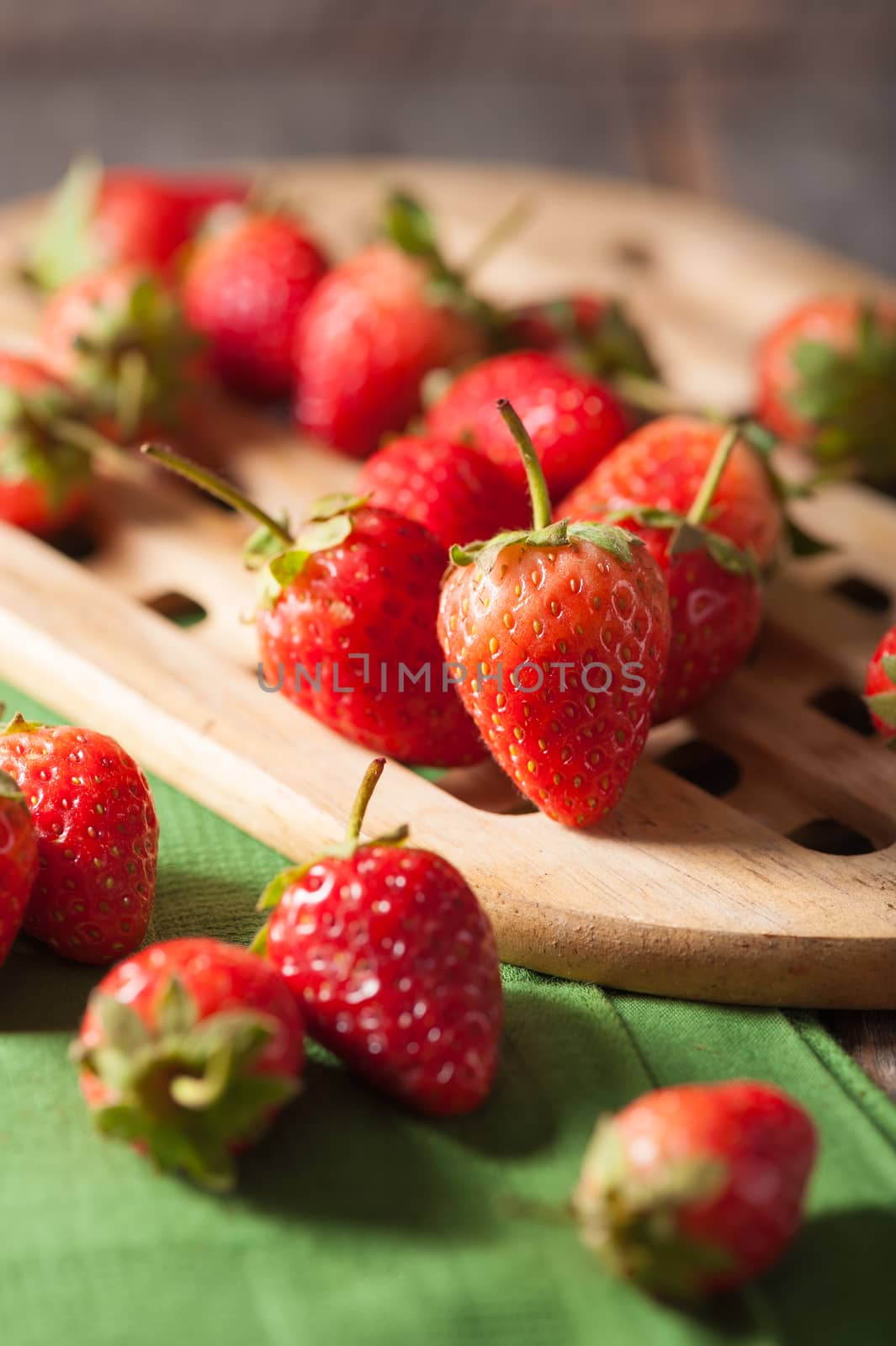 Strawberries on wood background in vintage style with low key scene.
