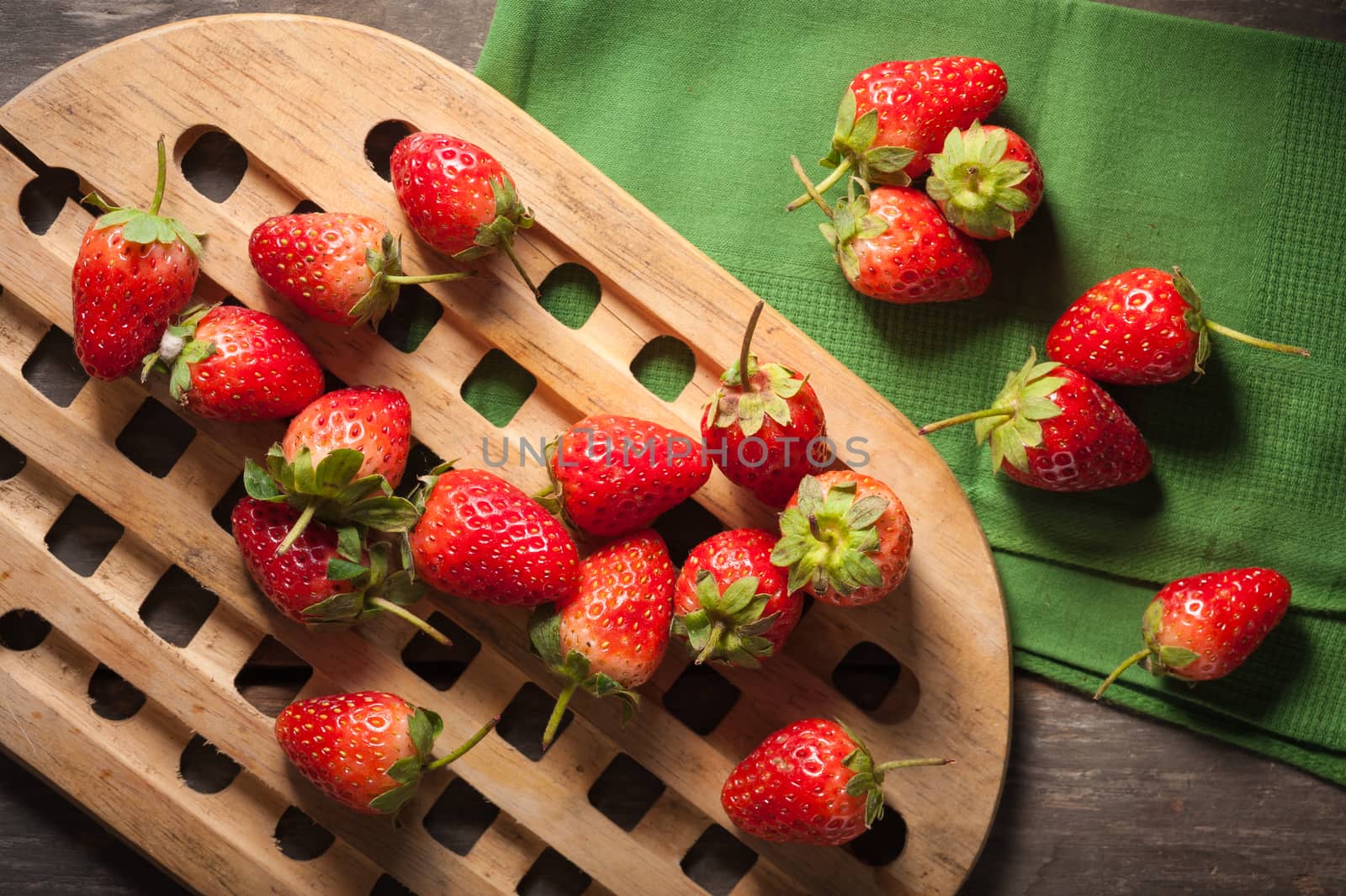 Strawberries on wood background in vintage style with low key scene.