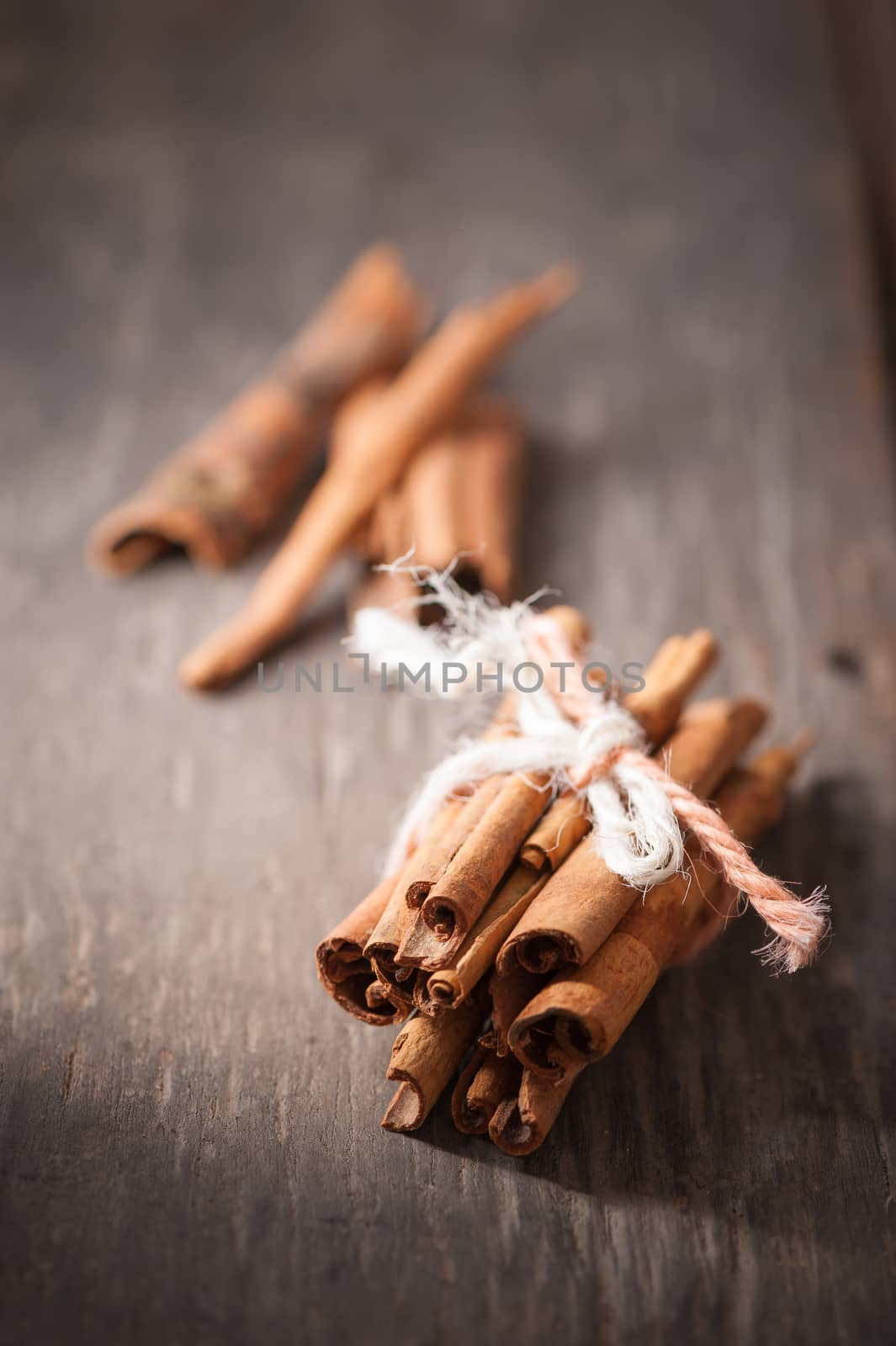 Cinnamon sticks on wood table with low key scene