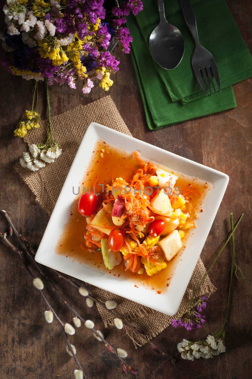 Thai mix fruit spicy dressed salad with low key scene