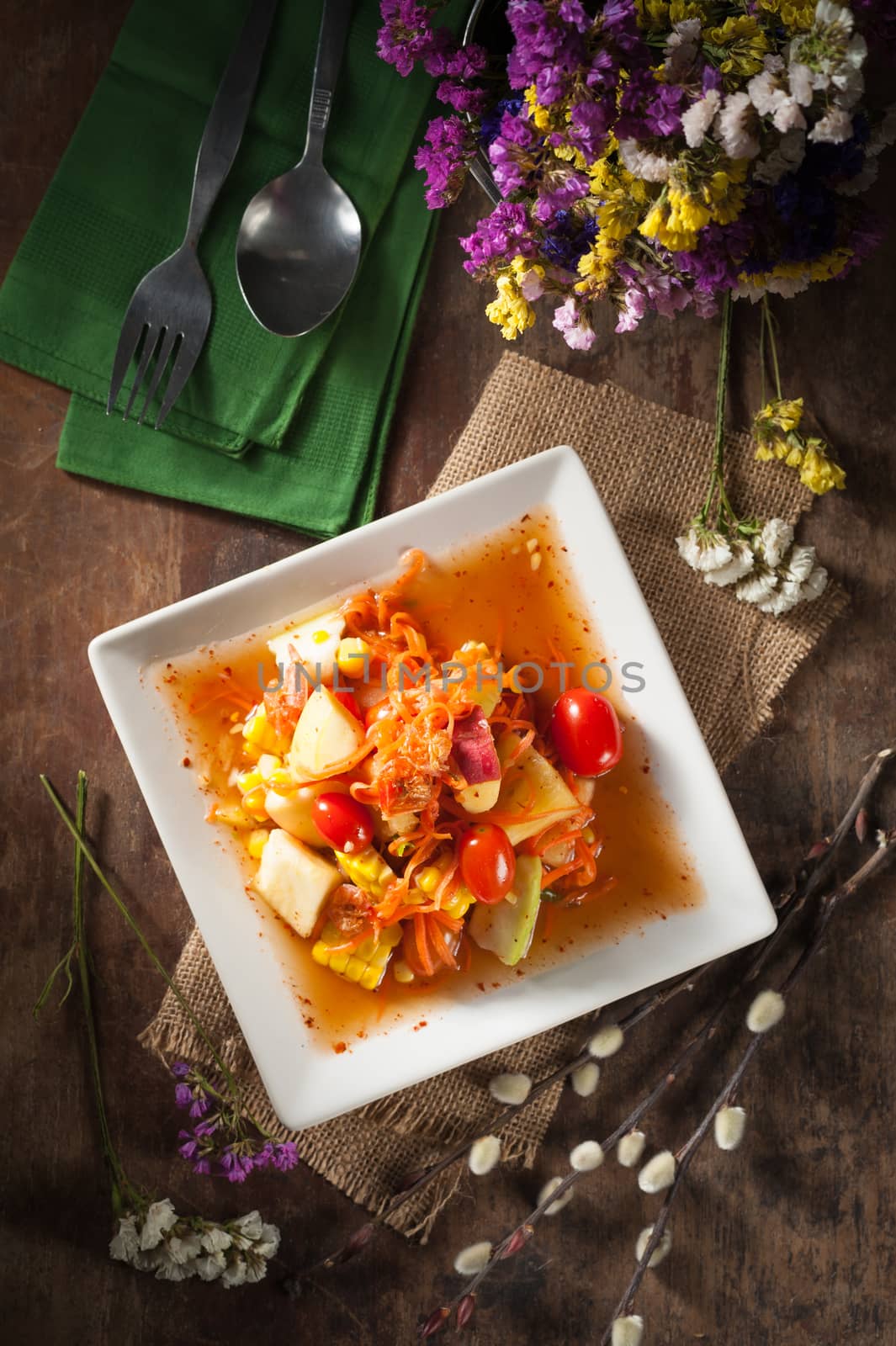 Thai mix fruit spicy dressed salad with low key scene