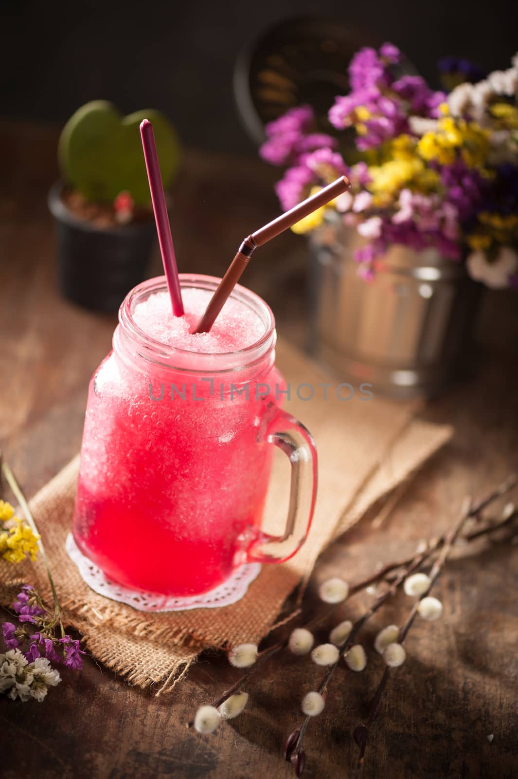 Red frozen cocktail on wood table in vintage stye with low key scene