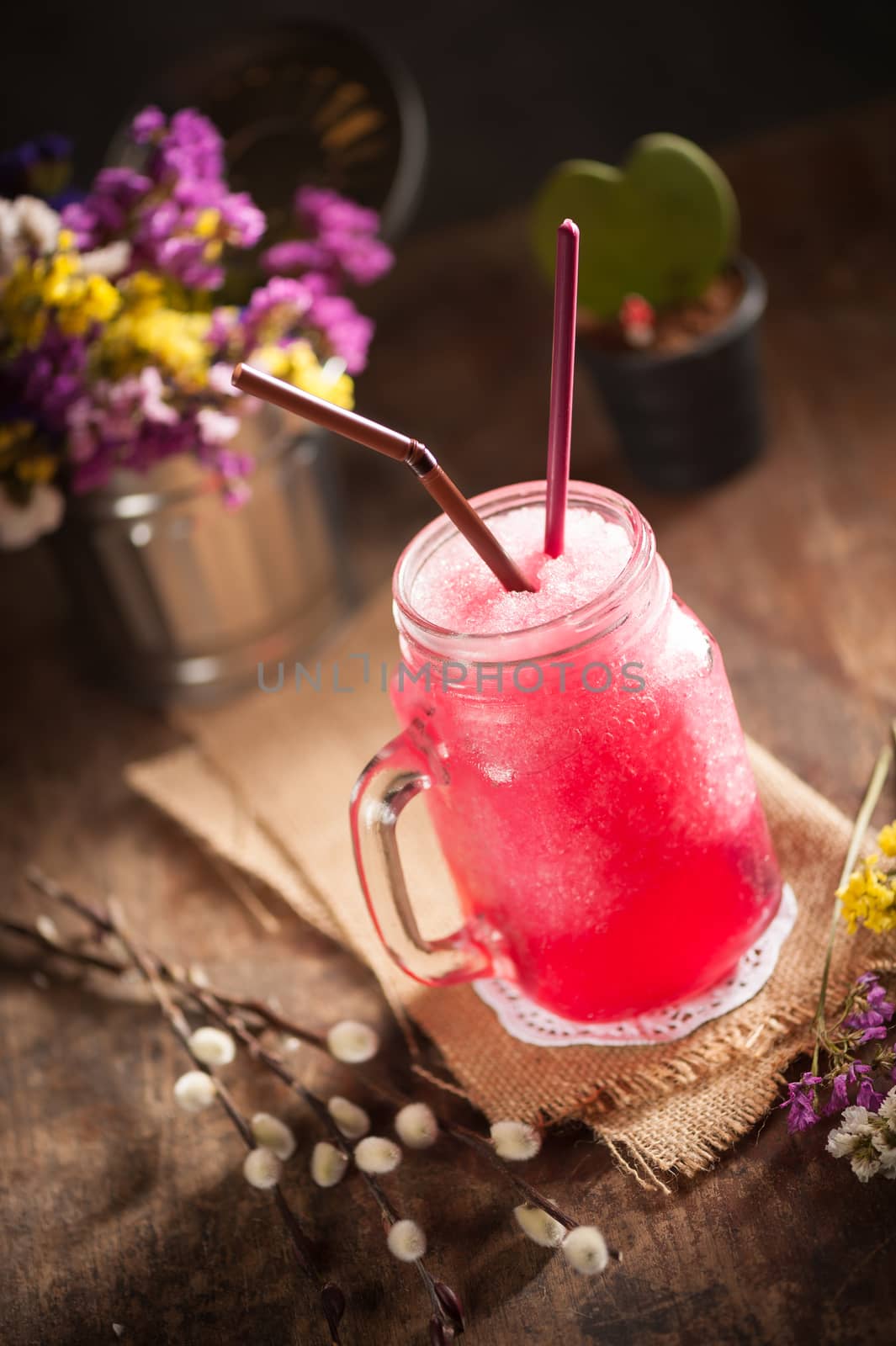 Red frozen cocktail on wood table in vintage stye with low key scene