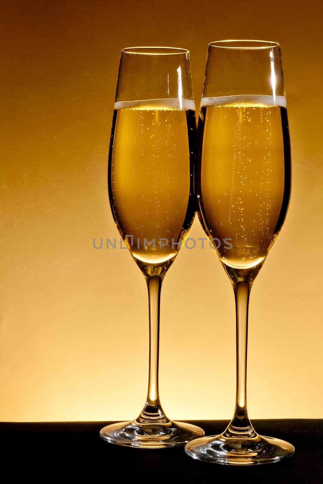two elegant champagne glasses by donfiore