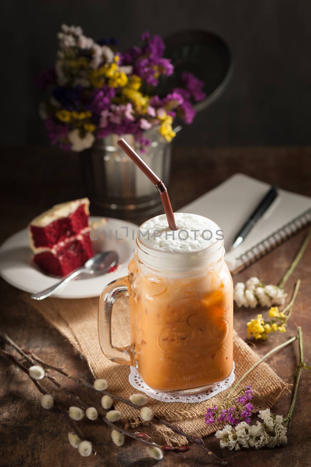Thai tea with milk cream in cafe with low key scene