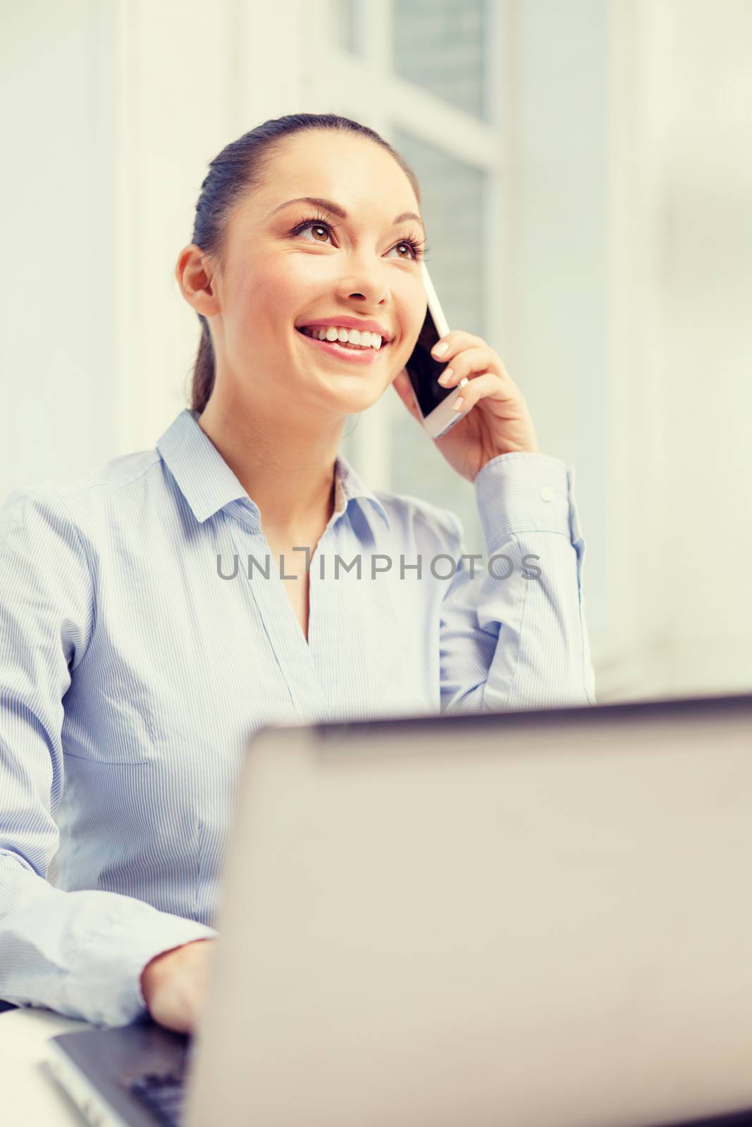smiling businesswoman with laptop by dolgachov