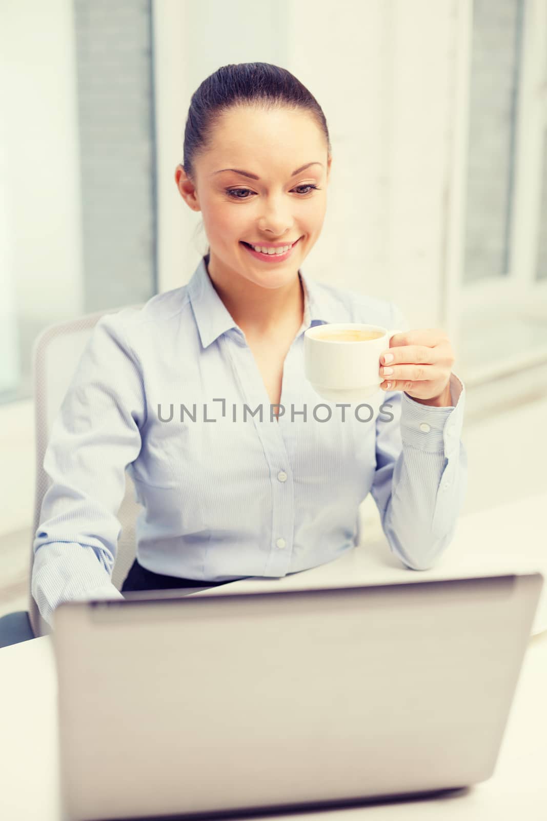 office, business and technology concept - smiling businesswoman or student with laptop computer and coffee in office