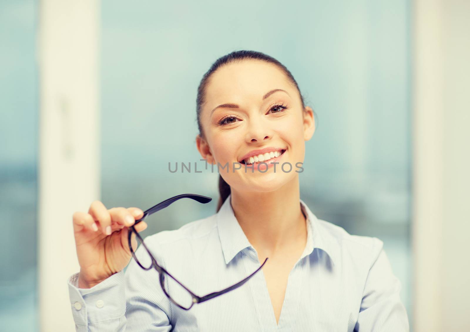 business and education concept - laughing businesswoman with eyeglasses