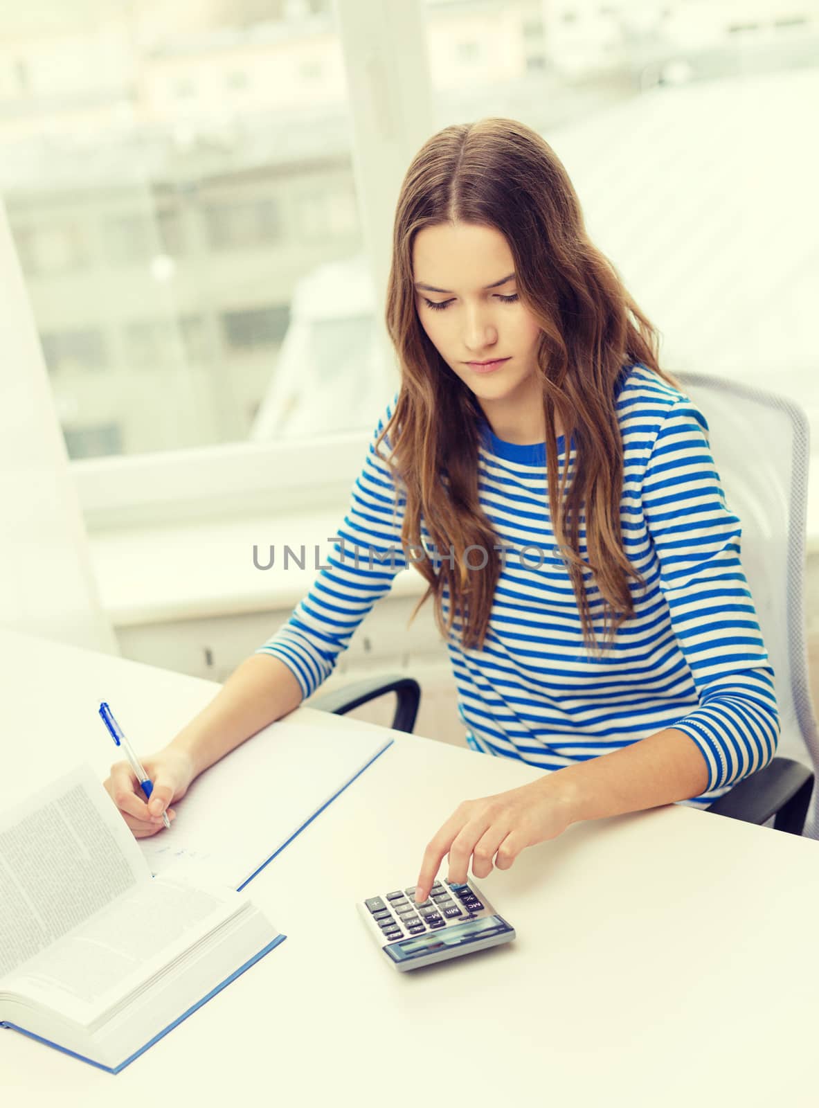 student girl with book, calculator and notebook by dolgachov
