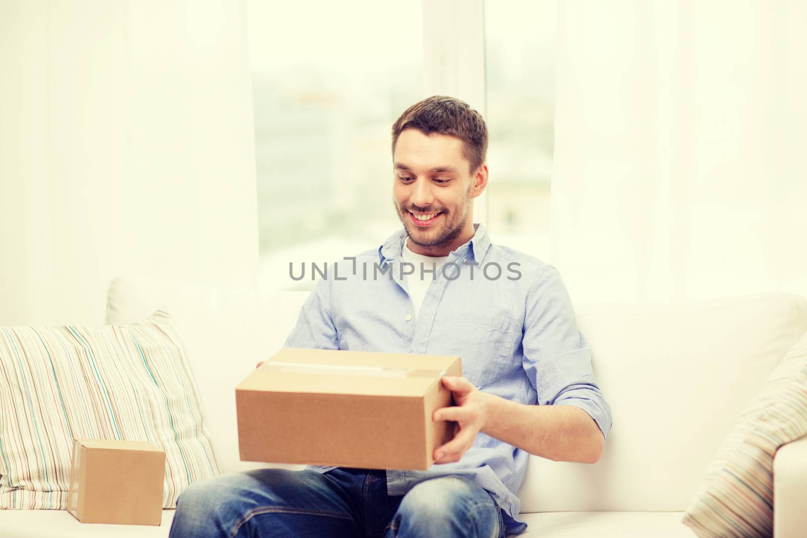 man with cardboard boxes at home by dolgachov