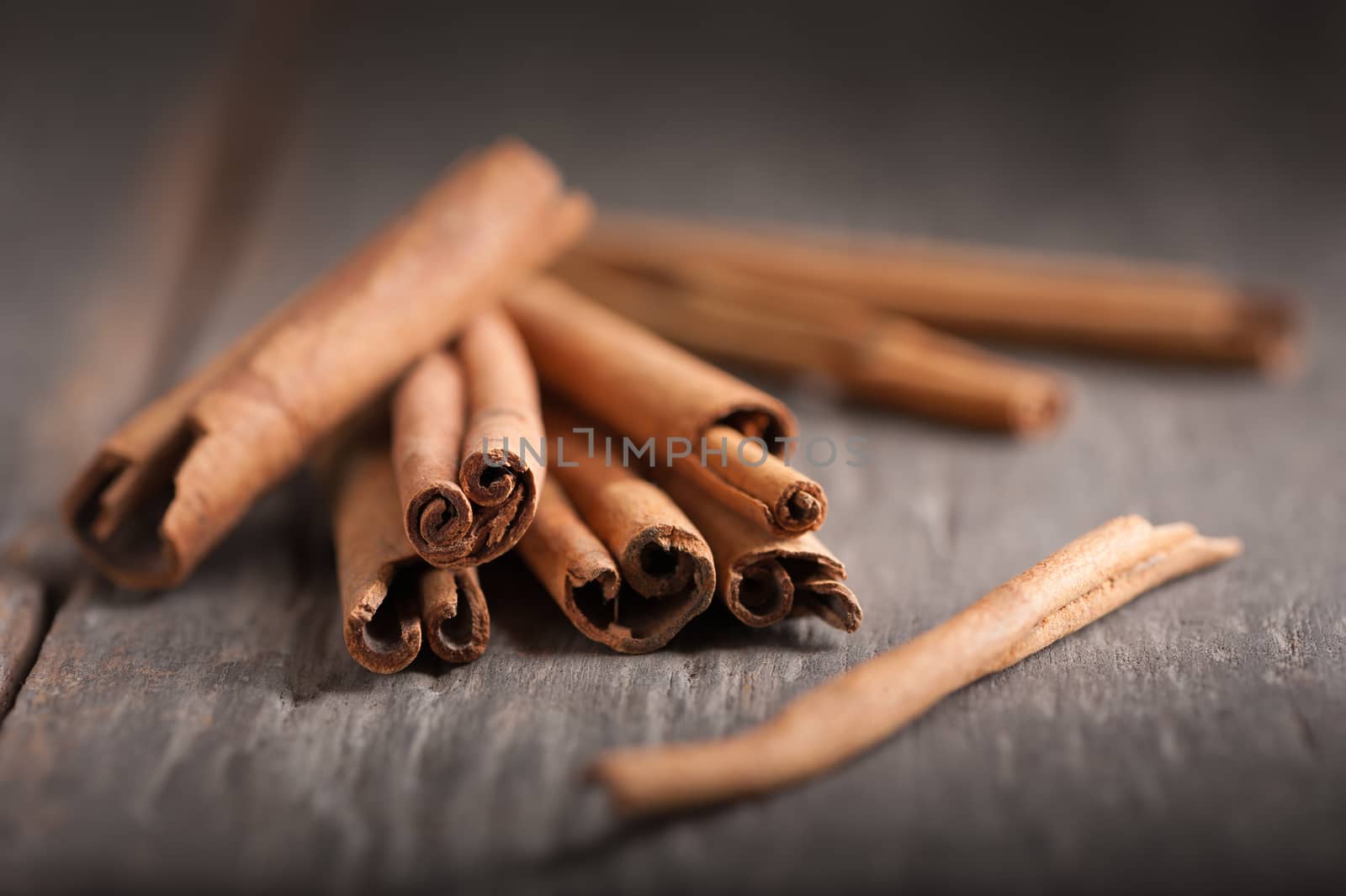Cinnamon sticks on wood table with low key scene