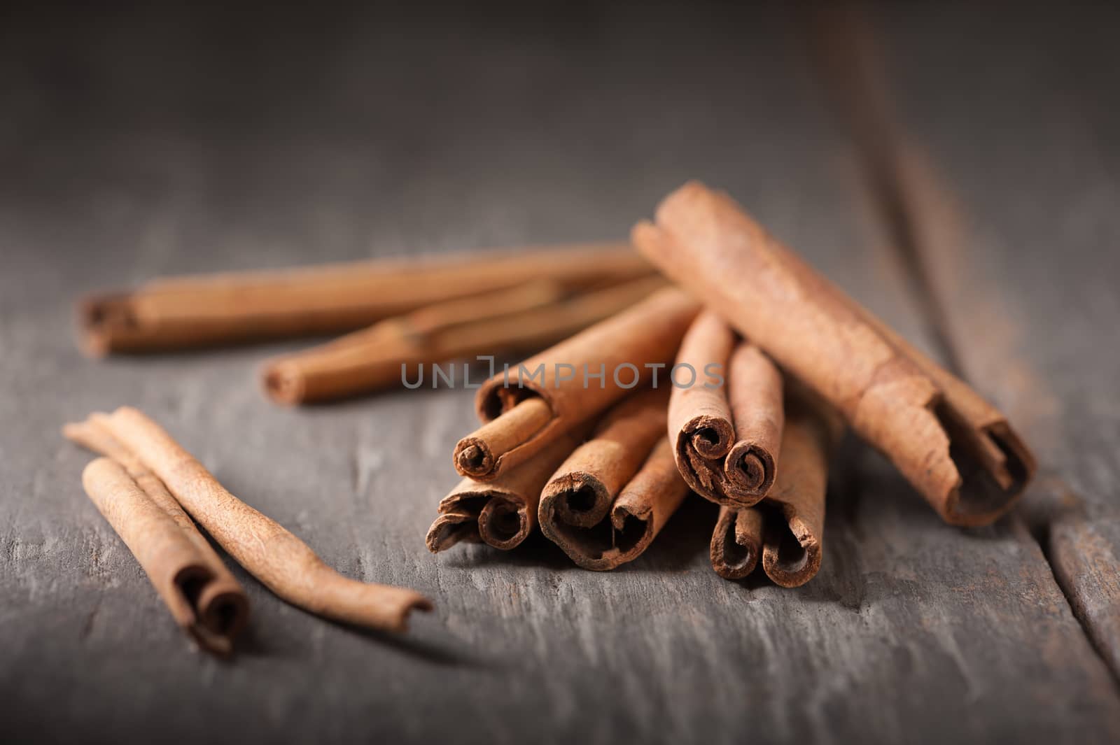 Cinnamon sticks on wood table with low key scene