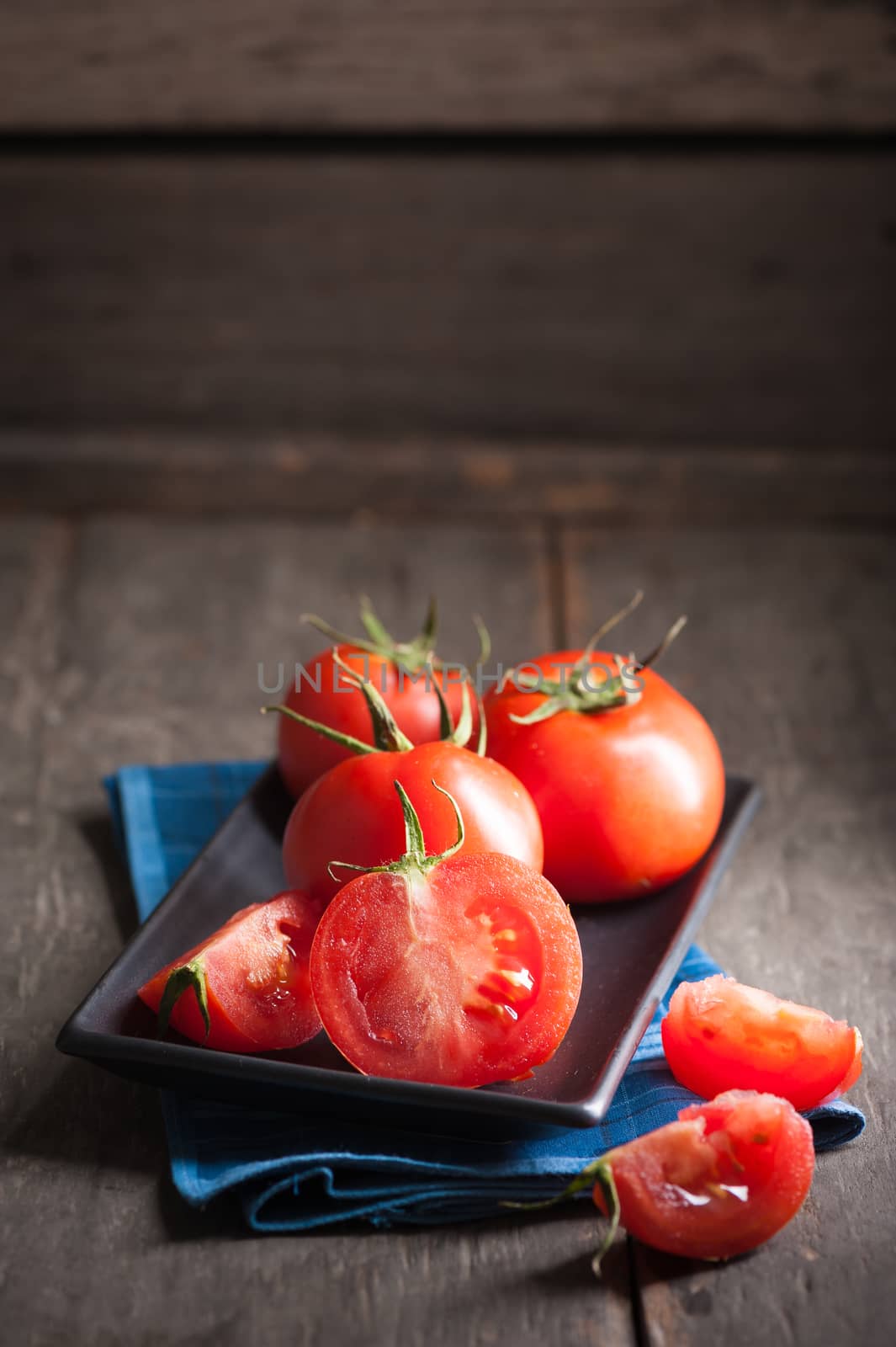Vegetables on wood table with low key scene