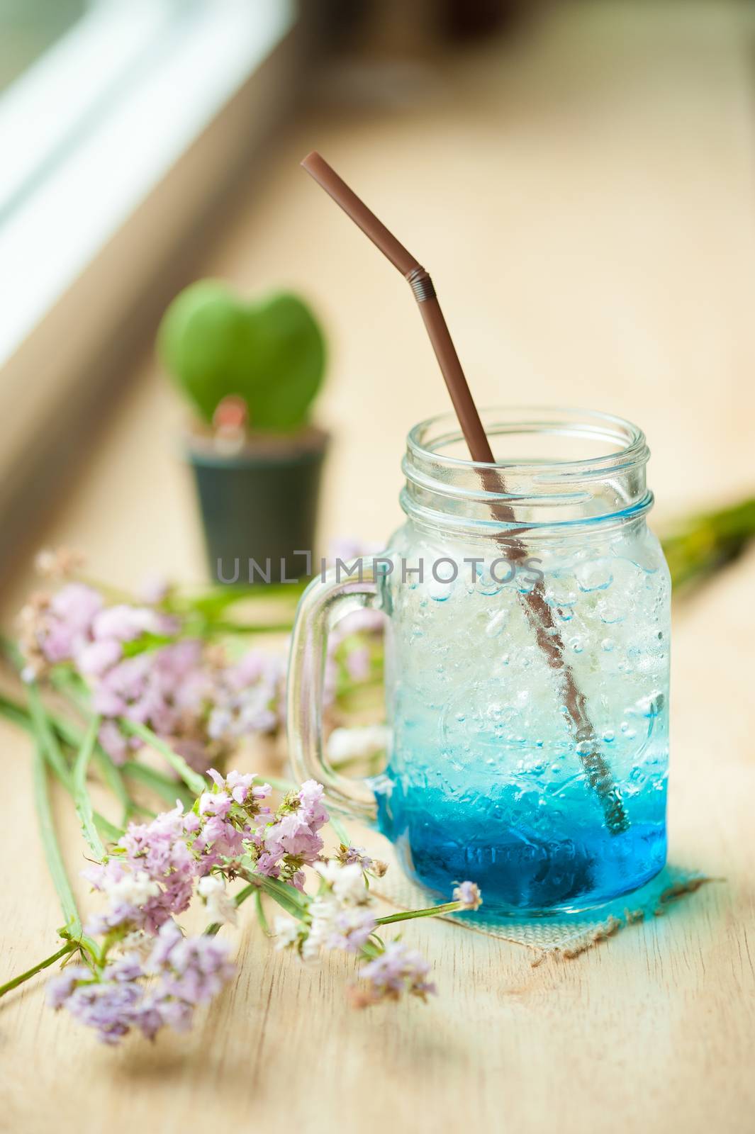 Blue Italian soda on wood bar in cafe