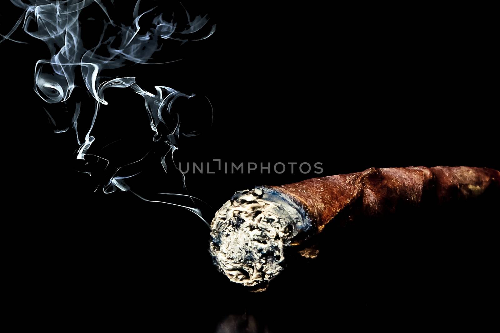 cigar with smoke with space for text over black background